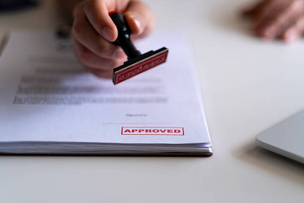 Lending concept. Pre-approved mortgage loan. Business Man Stamping With Approved Stamp On Document. Business approve Stamp and certificate concept. Businessman Hands Stamping a document