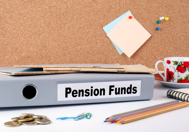 Pension Funds. Folder on office desk. Money, Coffee Mug and colored pencils.